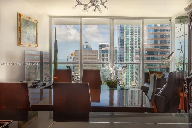 a view of living room with furniture and floor to ceiling windows