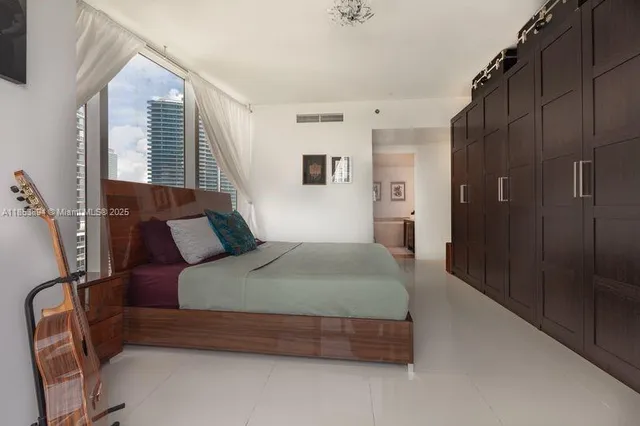 a bedroom with bed and window