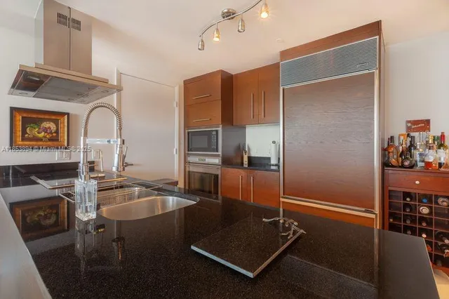 a kitchen with a refrigerator a sink and cabinets
