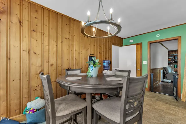 a kitchen with a table chairs refrigerator and chairs