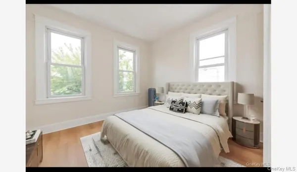 a bedroom with a bed and windows