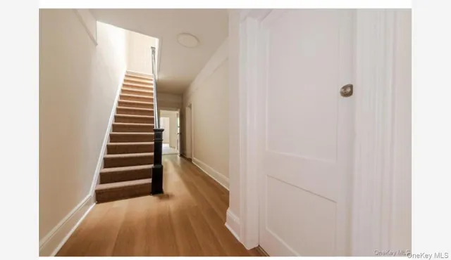 a view of a room with stairs and wooden floor