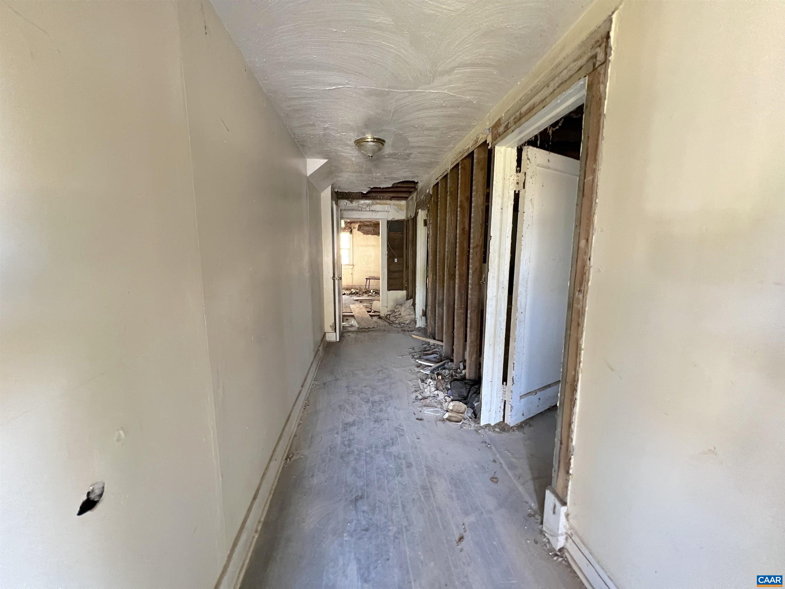 814-816 Ridge Street Charlottesville, VA 22902 - Photo 6 of 18 a view of a hallway with wooden floor and a refrigerator