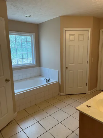 a bathroom with a tub and shower