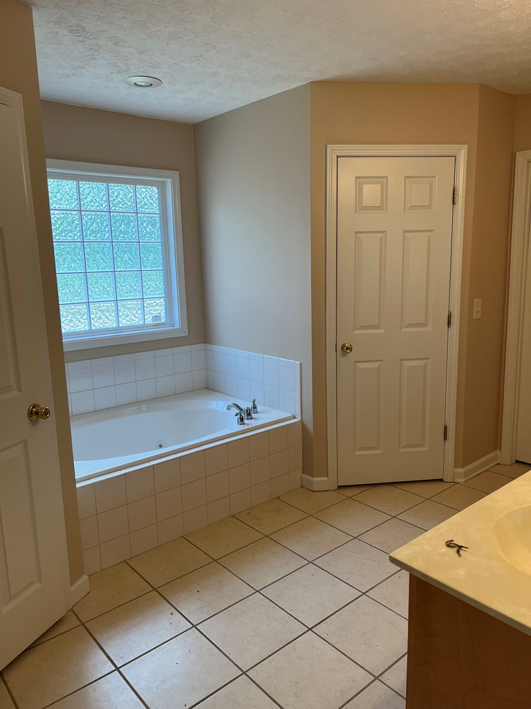 3003 Waterhill Drive Midland, GA 31820 - Photo 5 of 13 a bathroom with a tub and shower