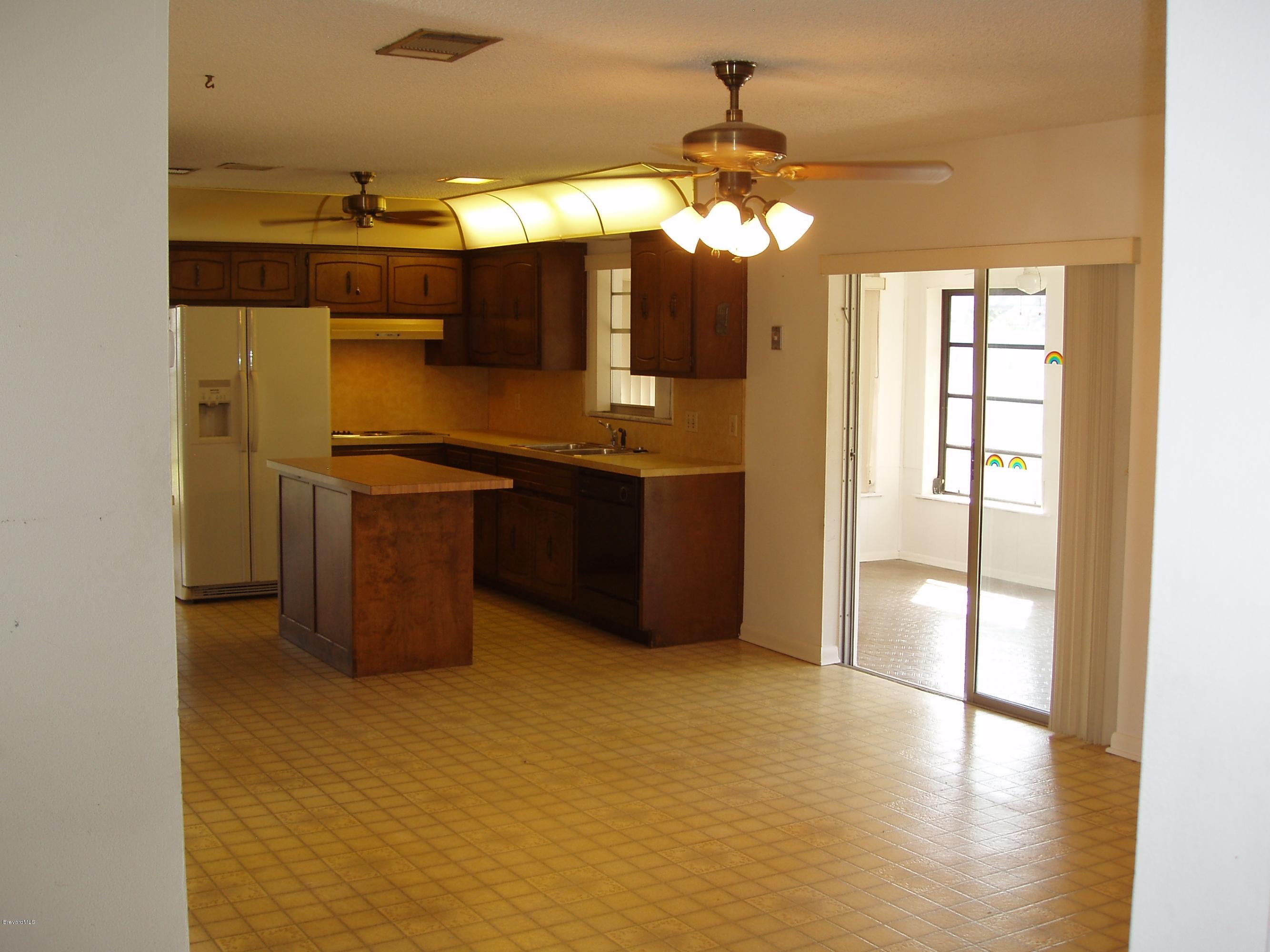 187 Sand Pine Road Indialantic, FL 32903 - Photo 7 of 29 Family Room to Kitchen & FL Room