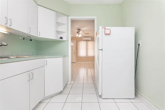 a view of a kitchen with a white cabinet and door