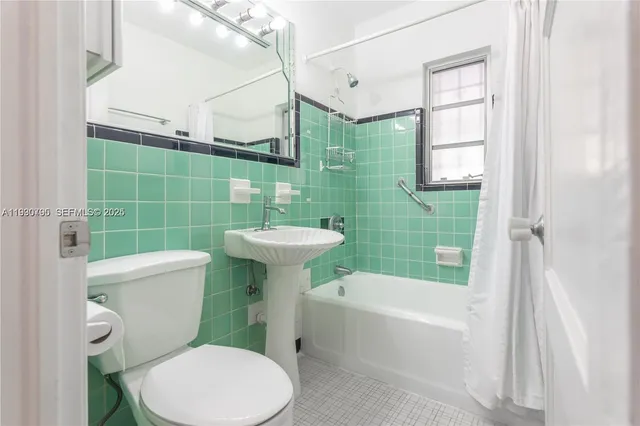 a bathroom with a sink a toilet and bathtub