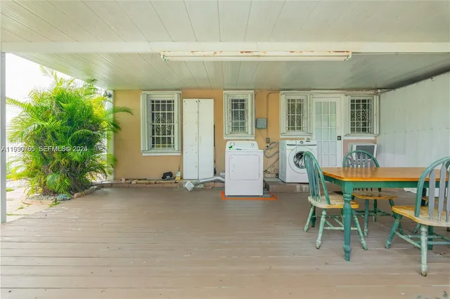 a view of a house with backyard sitting area and garden