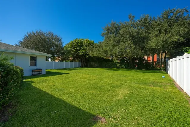 a view of a house with backyard and a garden