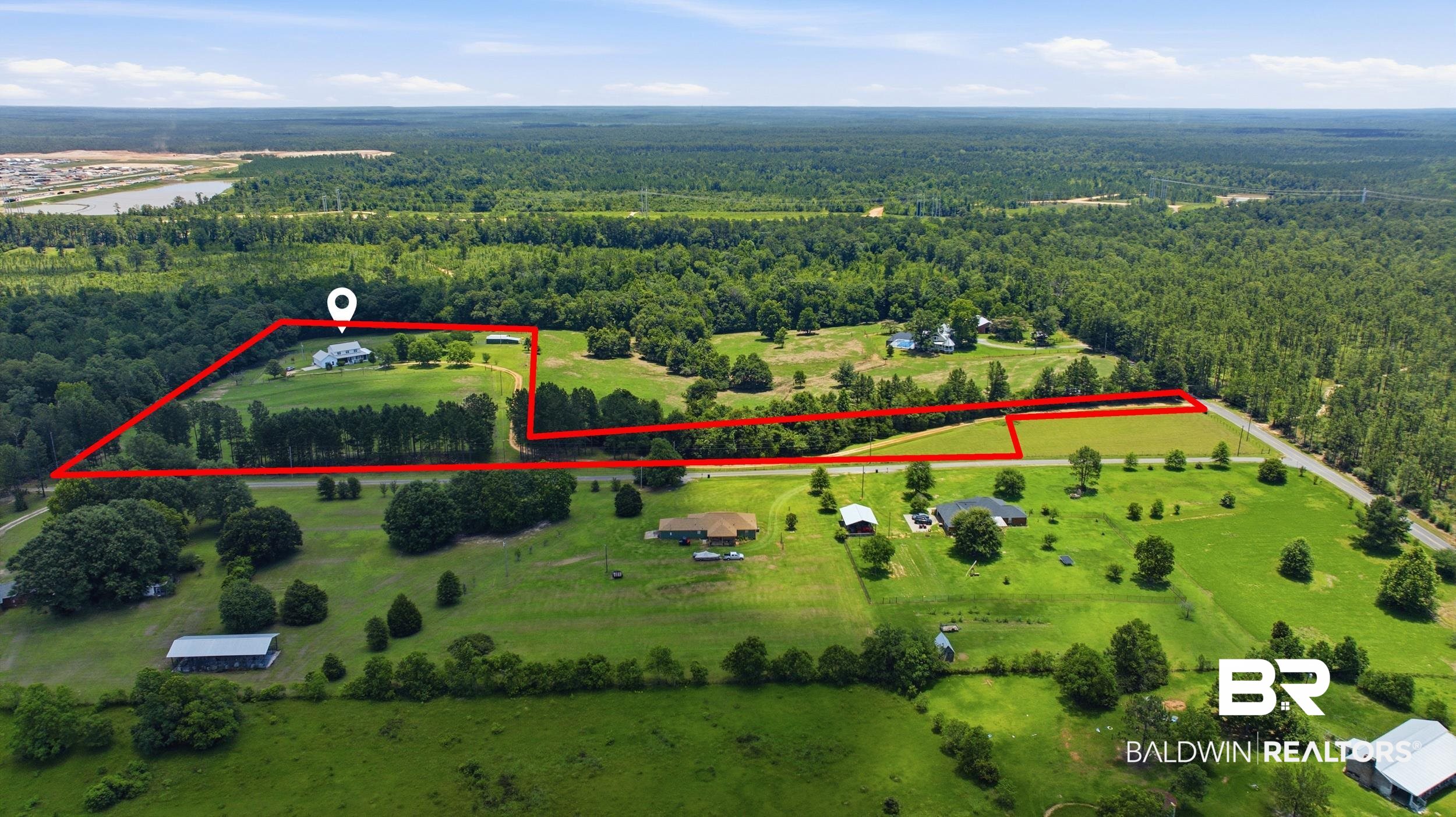 15855 Calvin Richerson Road Bay Minette, AL 36507 - Photo 81 of 83 Expansive acreage featuring a single-family residence, mature tree lines, open green fields, and direct road frontage