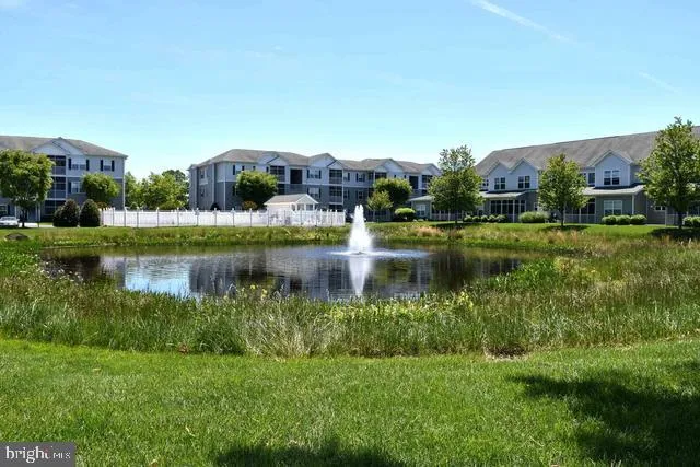 a view of a lake with houses in the back