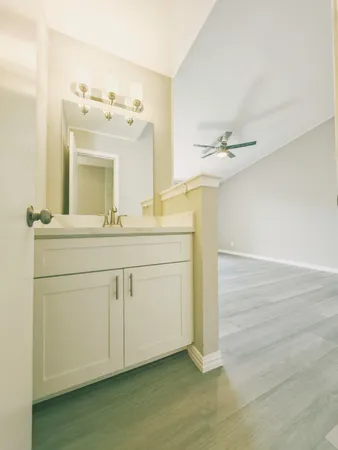 a bathroom with a double vanity sink toilet and shower