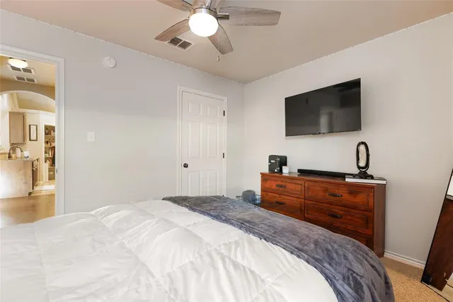 a bedroom with two beds and a chandelier