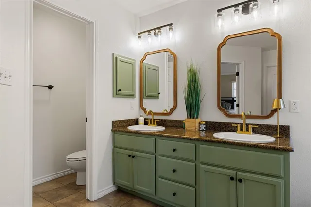 a bathroom with a granite countertop tub sink and mirror