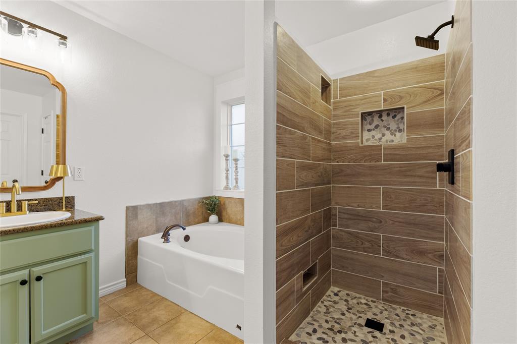 2565 Paddock Lane Robinson, TX 76706 - Photo 24 of 32 Full bath featuring a garden tub, vanity, a shower stall, and light tile patterned floors