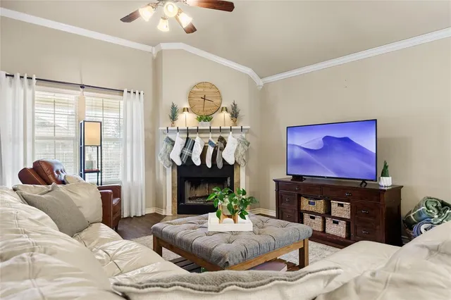 a living room with furniture a fireplace and a floor to ceiling window