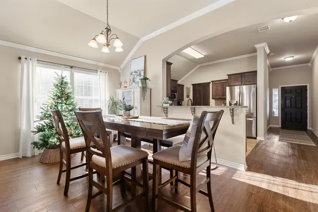 a kitchen with granite countertop a refrigerator and a sink