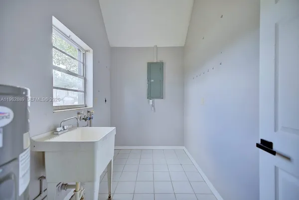 a bathroom with a sink a mirror and a window