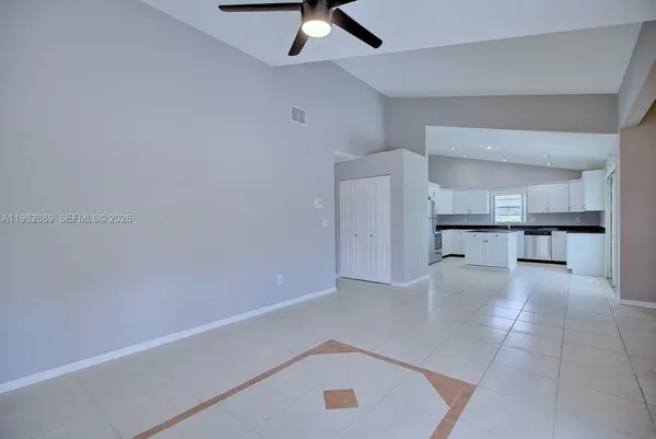 a view of kitchen with a sink and cabinets
