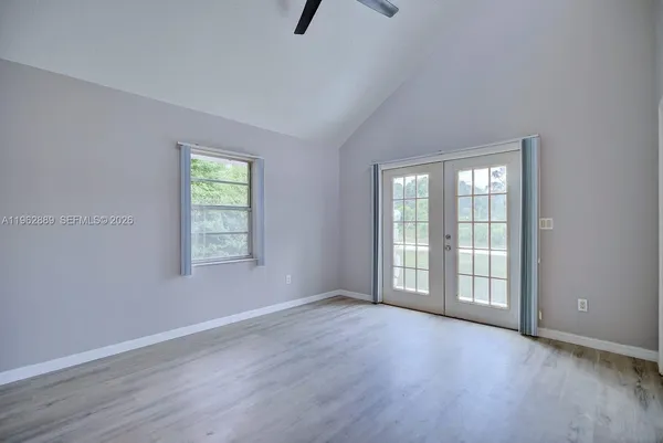 an empty room with windows and closet