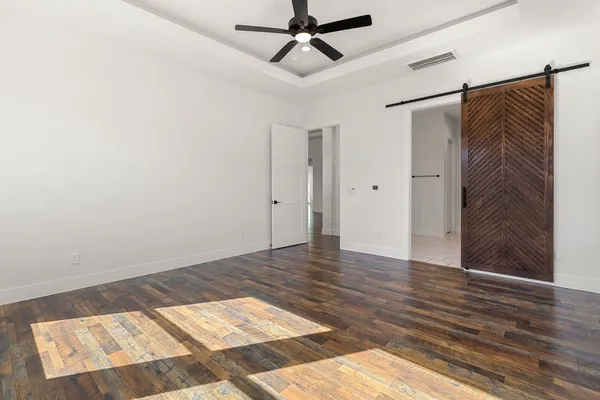 a view of a room with wooden floor and windows