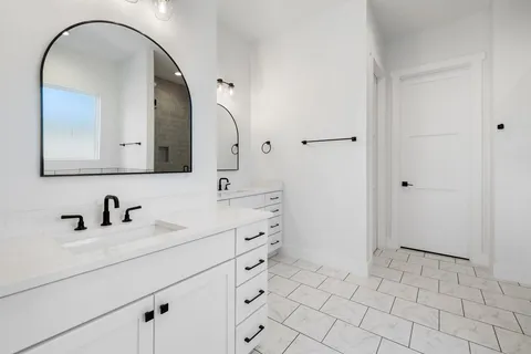 a bathroom with a sink a vanity and a mirror