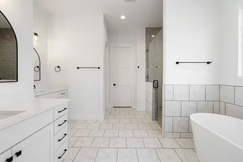 a bathroom with a bathtub and a shower