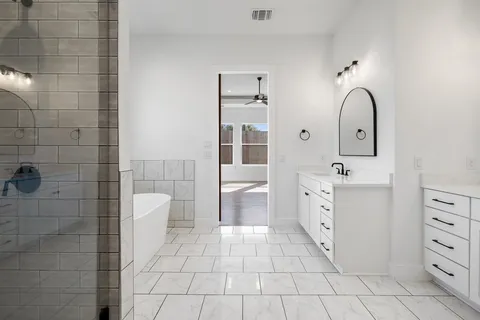 a bathroom with a sink a toilet and mirror