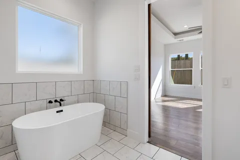 a white bath tub sitting next to a bathroom sink
