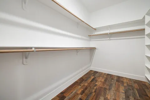 a view of a room with wooden floor