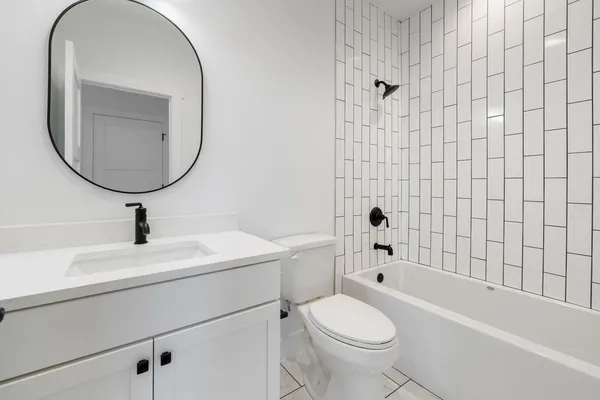 a bathroom with a sink a toilet and a mirror