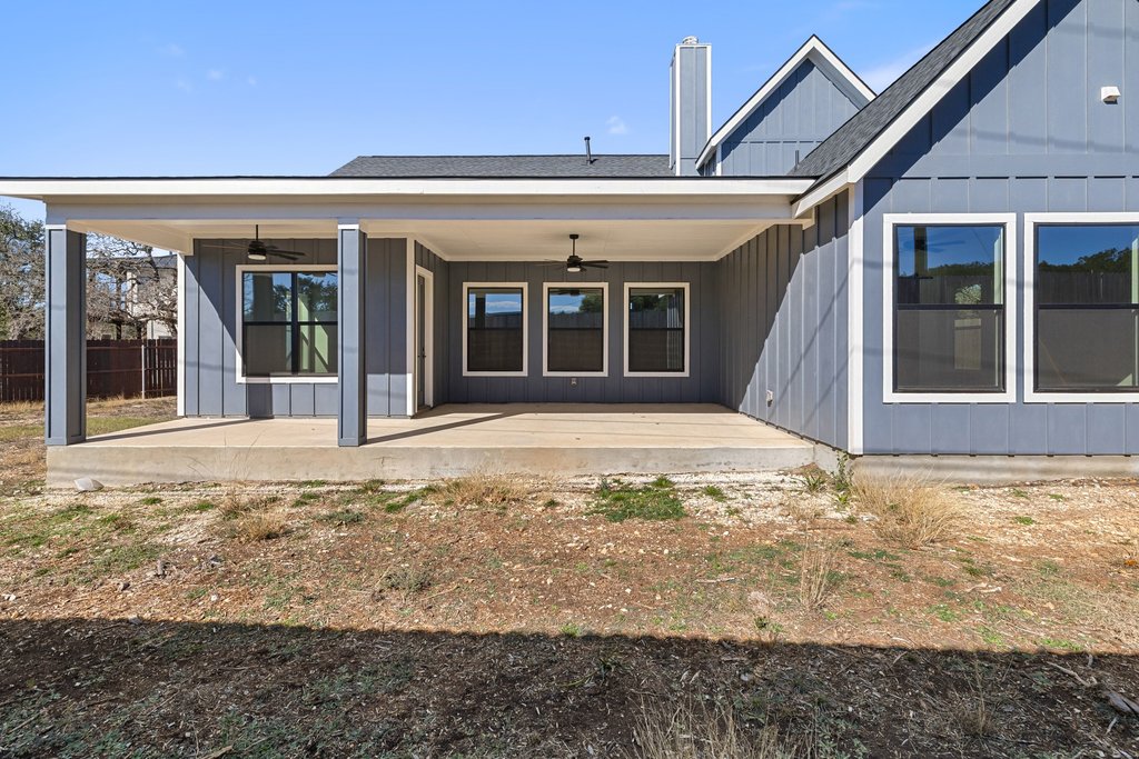 47 Peace Pipe Wimberley, TX 78676 - Photo 27 of 28 Rear view of property with a ceiling fan, a patio, and roof with shingles