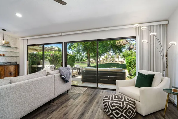 a living room with furniture and a large window