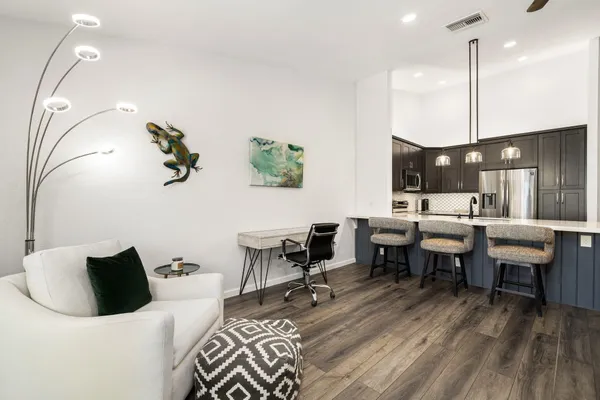 a living room with lots of furniture and a wooden floor