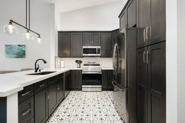 a kitchen with a sink stove and refrigerator