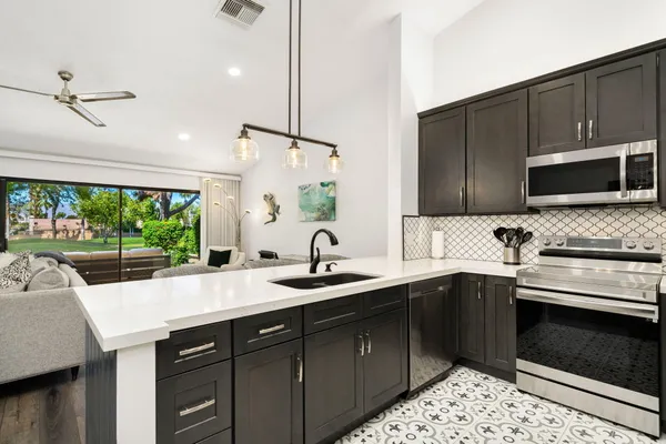 a kitchen with a sink stove and microwave
