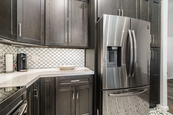 a kitchen with a refrigerator and a sink