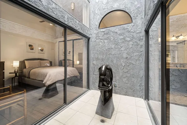 a bedroom with a bed and a window