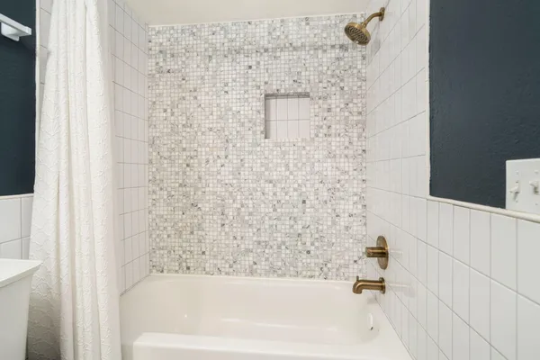 a view of a patio with couches table and chairs and potted plants