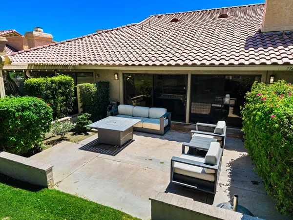 a view of a patio with table and chairs with wooden floor and fence