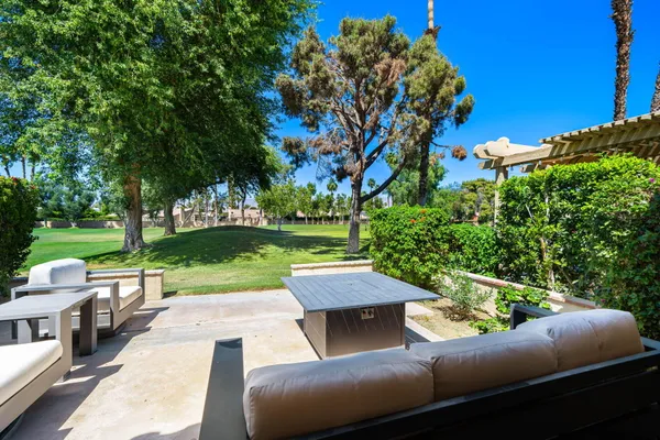 a view of backyard with outdoor seating and green space