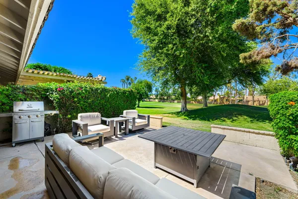 an aerial view of residential house with outdoor space and trees all around