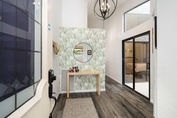 a view of a hallway with entryway wooden floor and front door