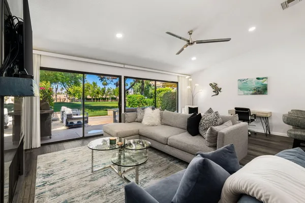 a living room with furniture and a large window