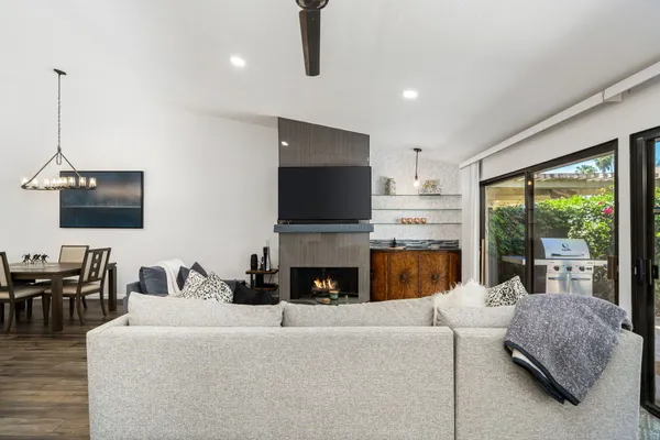 a living room with furniture fireplace and flat screen tv