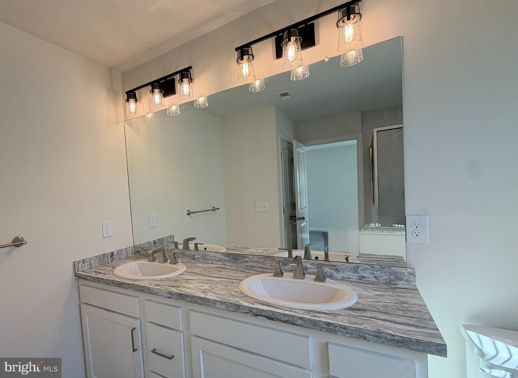 78 Tansboro Road Berlin, NJ 08009 - Photo 32 of 41 a bathroom with a granite countertop sink and a mirror