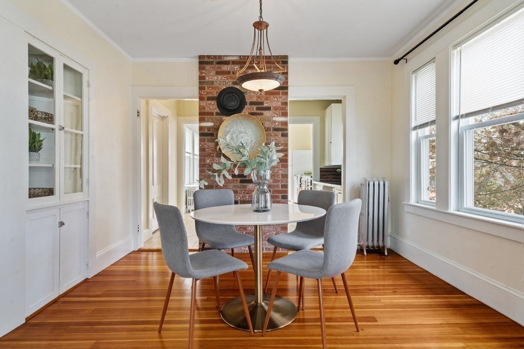 5 Crescent Street Wakefield, MA 01880 - Photo 5 of 27 a dining room with wooden floor a chandelier a glass table and chairs