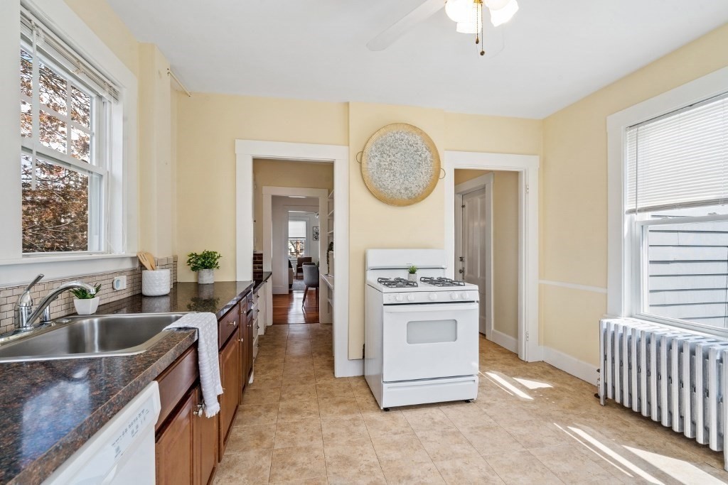 5 Crescent Street Wakefield, MA 01880 - Photo 8 of 27 a kitchen with stove a sink and a refrigerator
