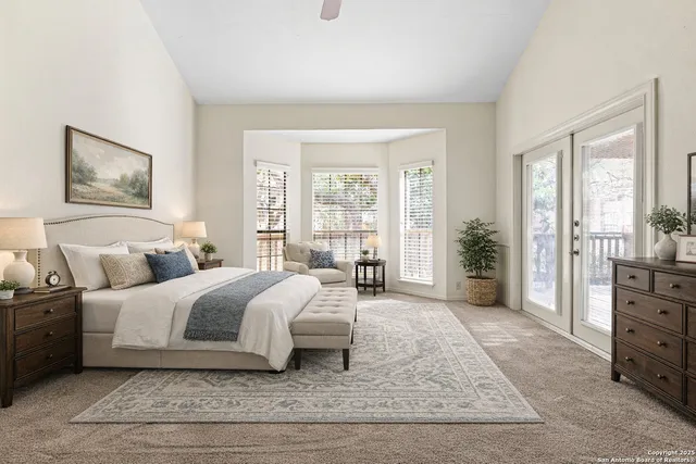 a spacious bedroom with a large bed couch and a window